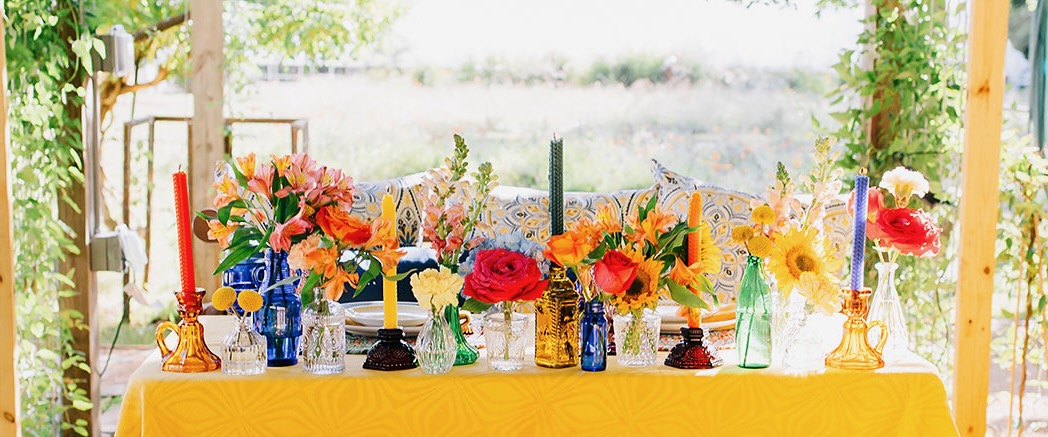 Sweetheart Table with Colorful Bottles and Vases